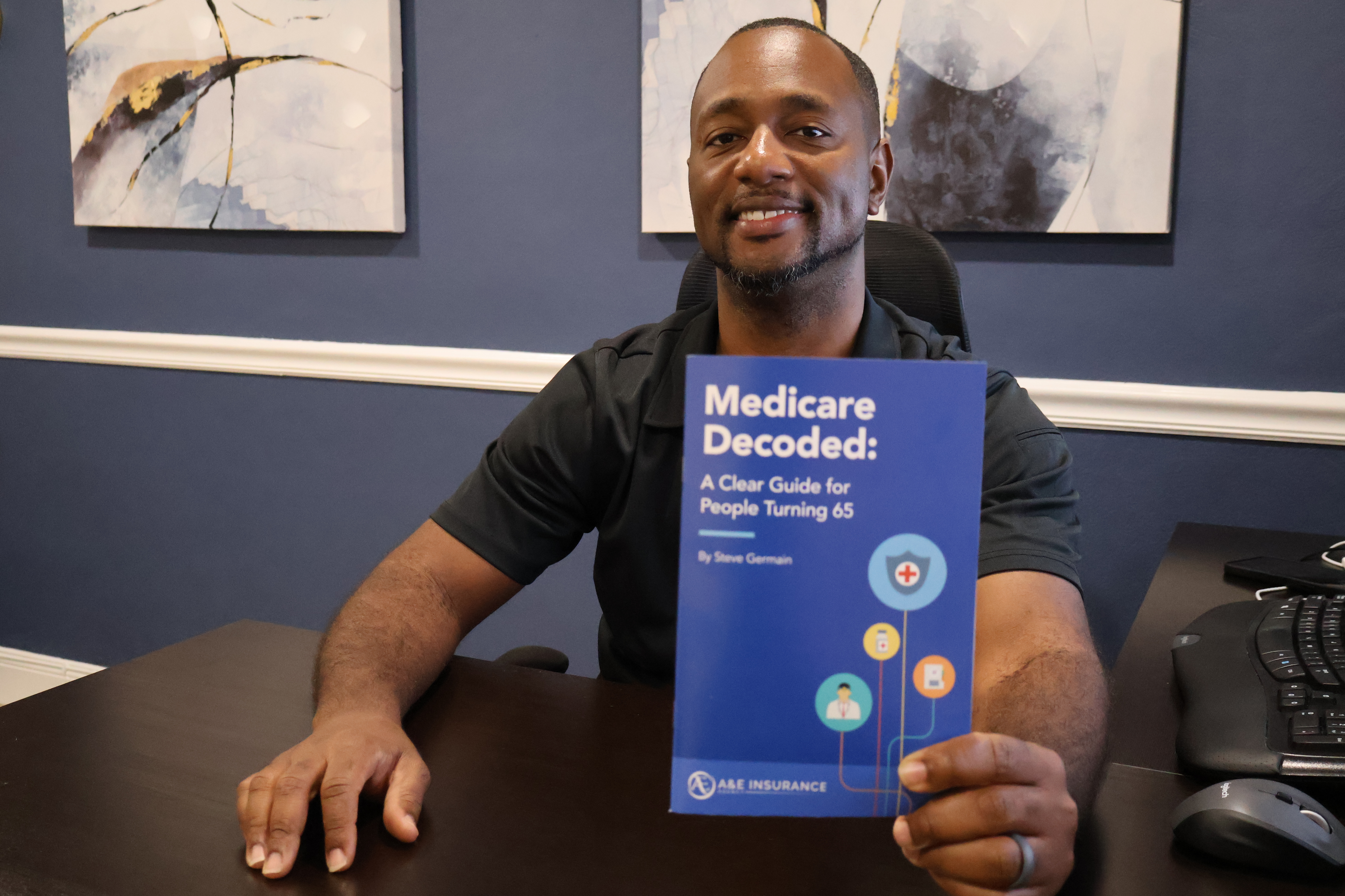 Steve Germain holding Medicare Decoded book